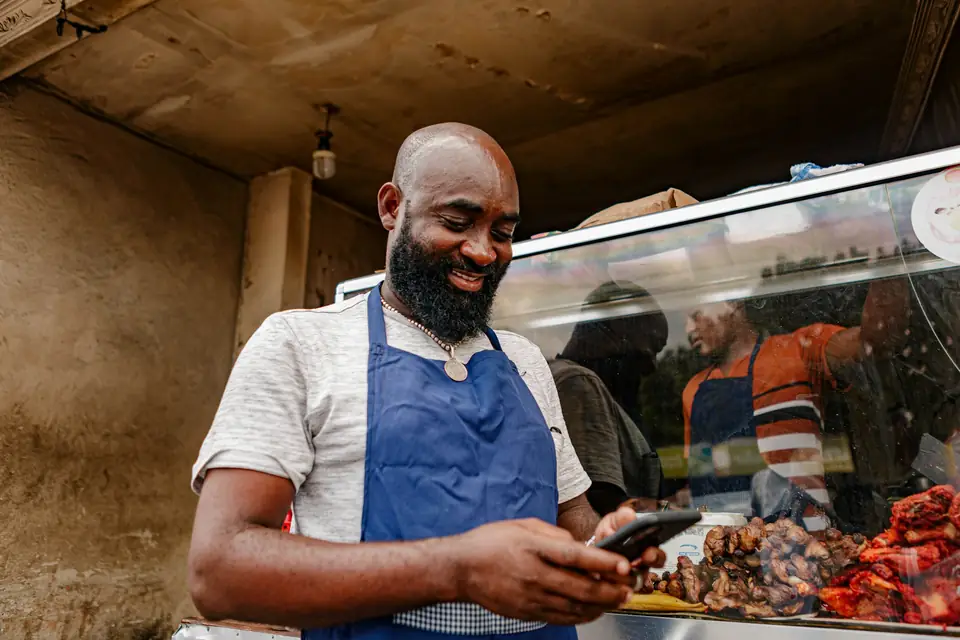 A small-business owner checking his phone