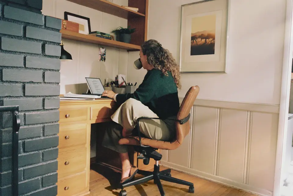 A small-business owner working at a laptop